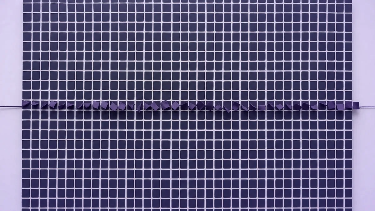 A navy grid of cells with one violet diagonal line, a static register turning live